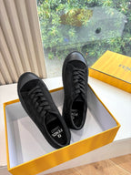 Black lace-up Fendi sneakers, side view, with embossed pattern and tread sole