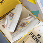 White unisex low-top sneakers with multicolor logo patches and stitched panels