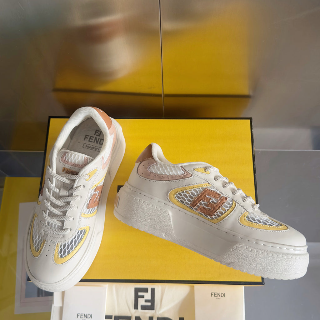 White unisex low-top sneakers with brown and yellow emblem patch and laces
