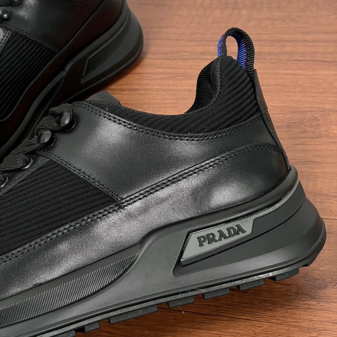 Black Prada unisex sneaker detail, side logo patch and smooth leather overlay