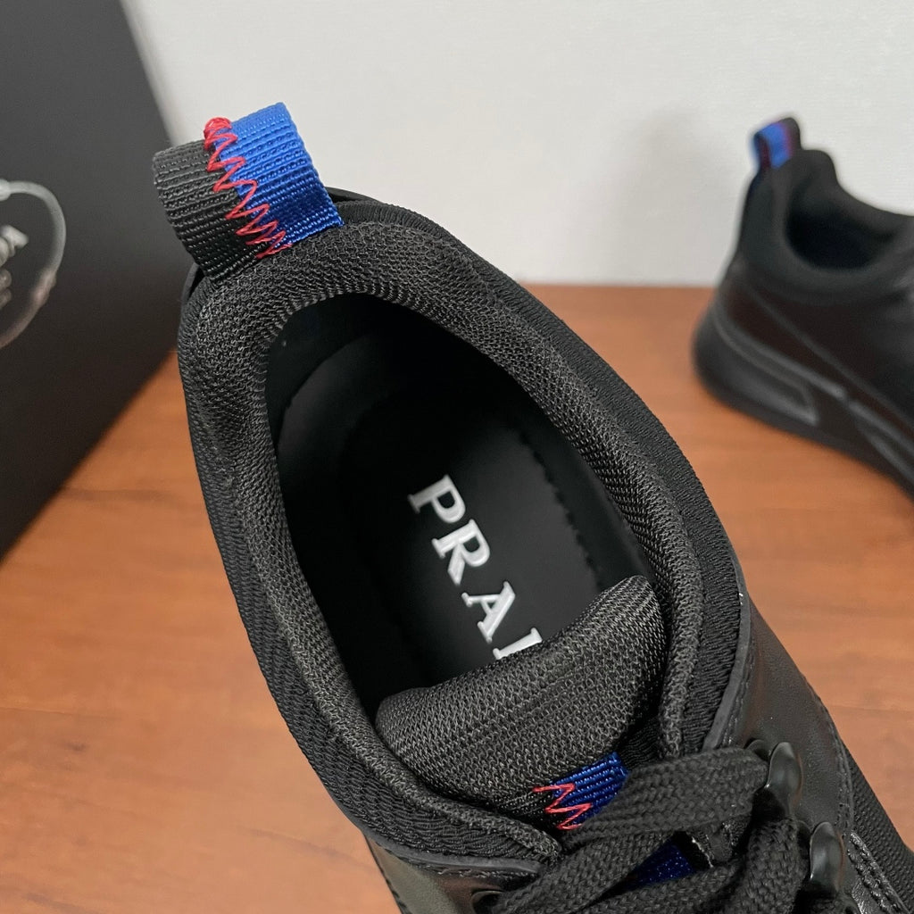 Black Prada unisex sneaker, heel label visible through collar and knit lining
