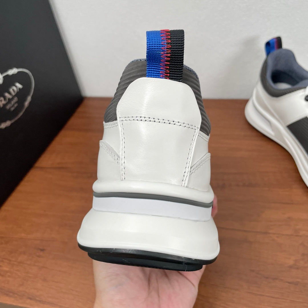 Prada unisex sneakers heel view, white leather back with blue-striped pull tab