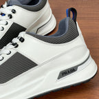 Prada unisex sneakers side detail, white trim, dark gray fabric, PRADA badge