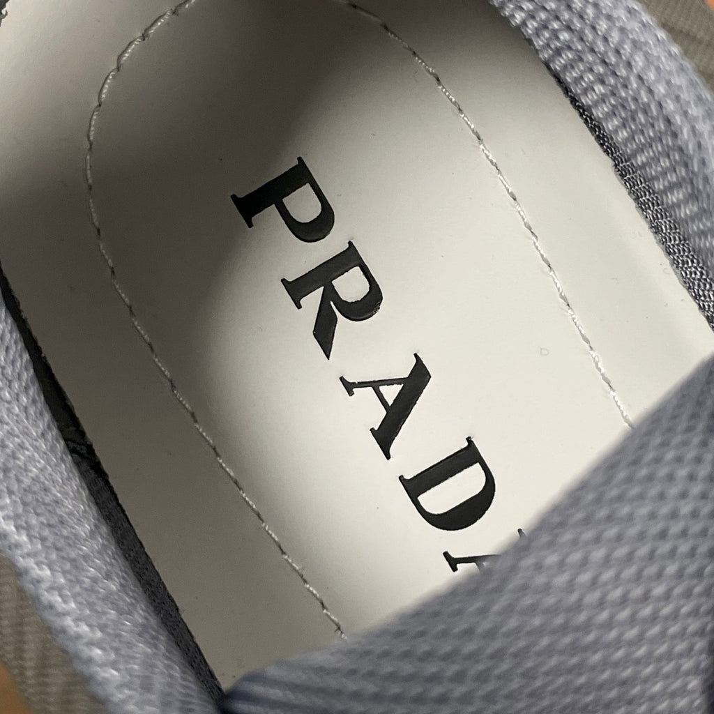 Prada insole label on unisex sneakers, printed PRADA on light fabric