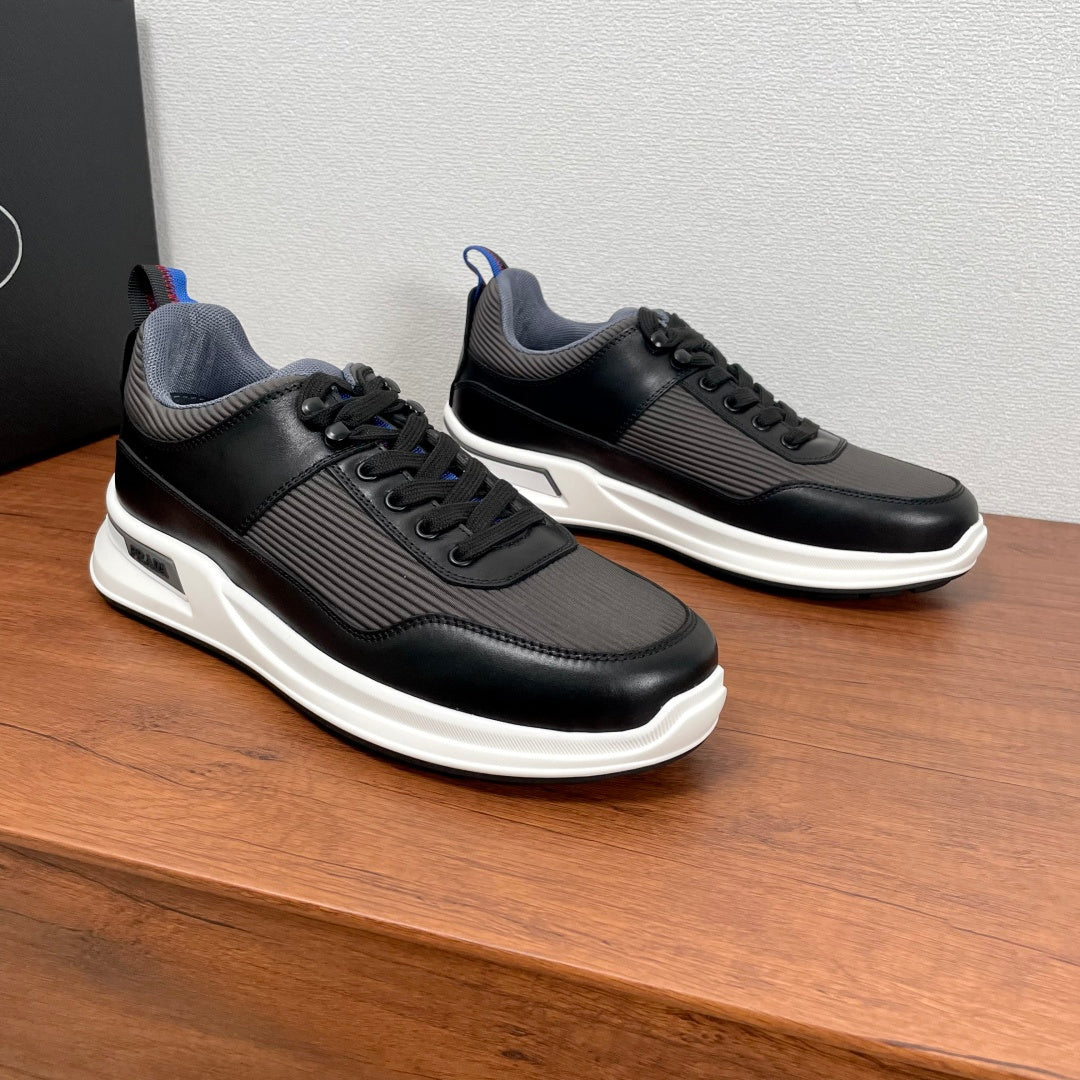 Unisex lace-up sneakers, black leather-look with gray panels and white soles