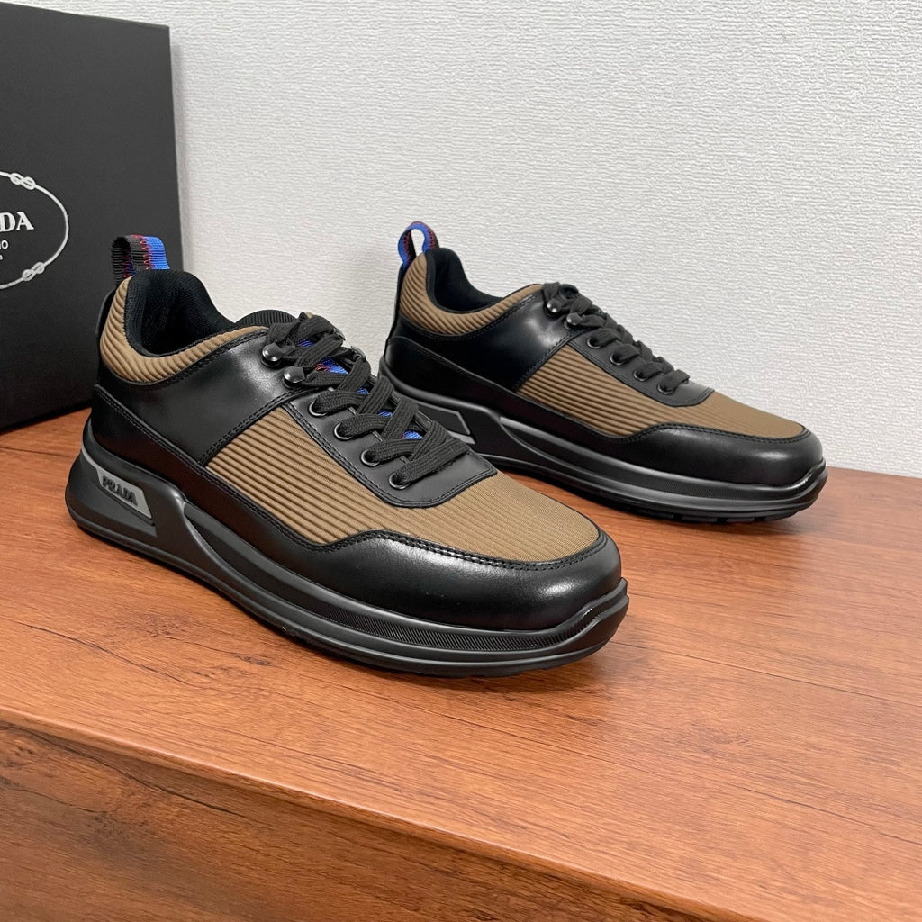 Prada unisex sneakers, side view pair, black leather with tan striped panels