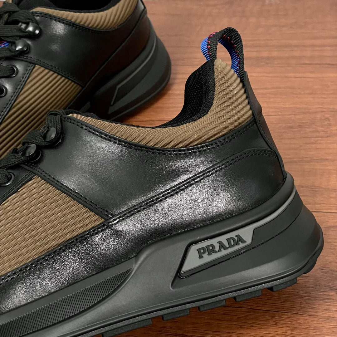Prada unisex sneaker side, black leather trim over tan knit with PRADA plaque