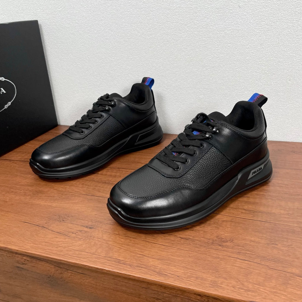 Prada unisex lace-up sneakers in black leather with blue-red pull tab detail