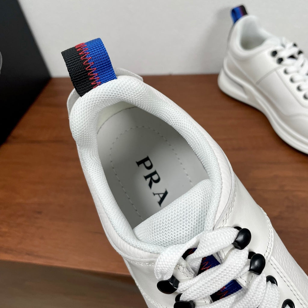 Prada unisex sneaker inner view, white lining with PRADA logo and blue-red collar