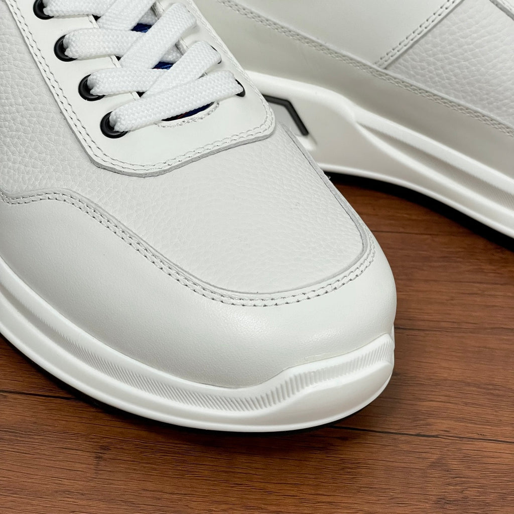 Prada unisex sneaker toe close-up, white leather with white laces and cushioned sole