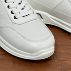 Prada unisex sneaker toe close-up, white leather with white laces and cushioned sole
