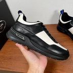 Prada unisex leather sneaker, black upper with white side stripe and PRADA logo label