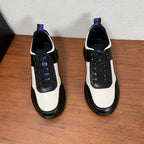 Prada unisex sneakers pair, white panels with black toe and sides, black laces, grippy sole