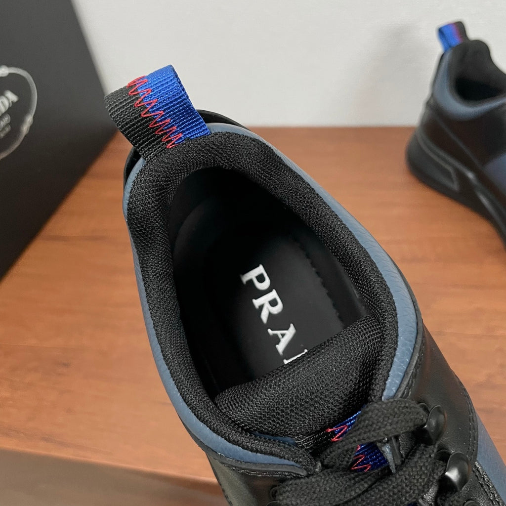 Prada unisex sneaker interior with PRADA logo on black lining and blue collar