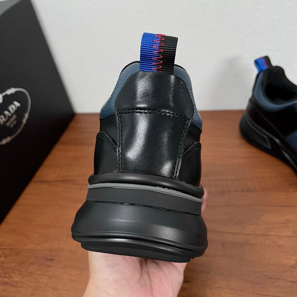 Prada unisex sneaker heel with cushioned collar and blue-red knit pull tab