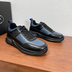 Prada unisex sneakers pair with black soles and black/blue panels, lace-up