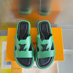 Louis Vuitton mint green slide sandals with black footbeds and front logo emblems