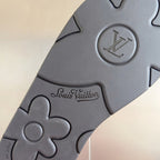 Dark gray slide sandal close-up with Louis Vuitton logo and LV monogram on strap