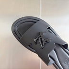 Dark gray leather slide sandal upper with cutout strap and embossed Louis Vuitton logo