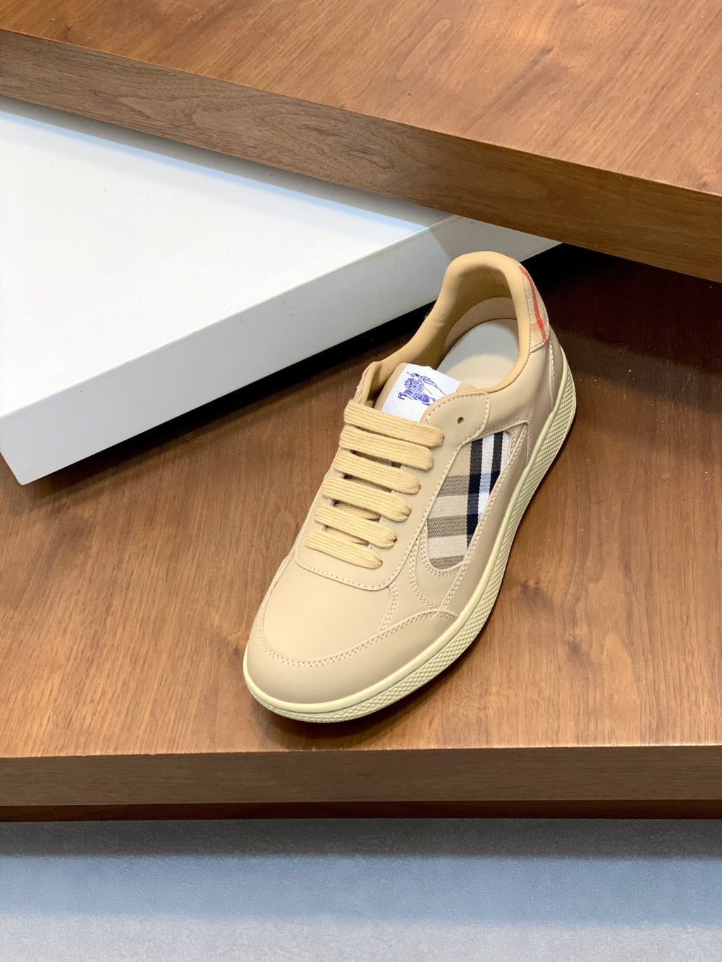 Burberry beige lace-up sneakers with tartan side panel, on display