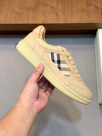Burberry beige sneakers with blue-and-white plaid panel and textured sole