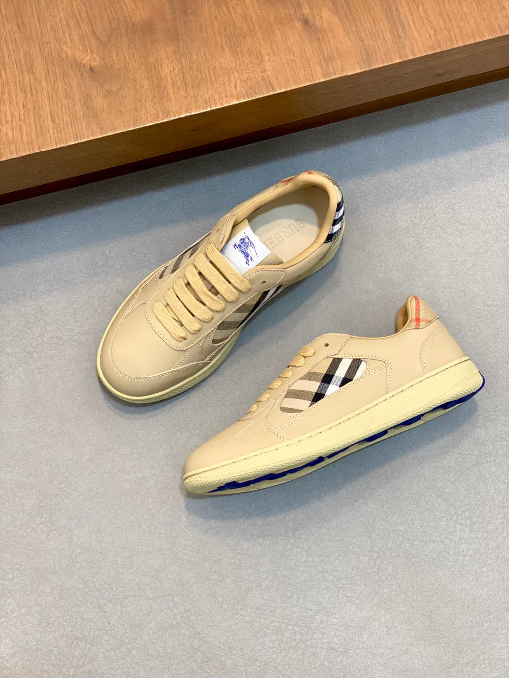 Burberry beige sneakers, side view with blue-and-white check accent