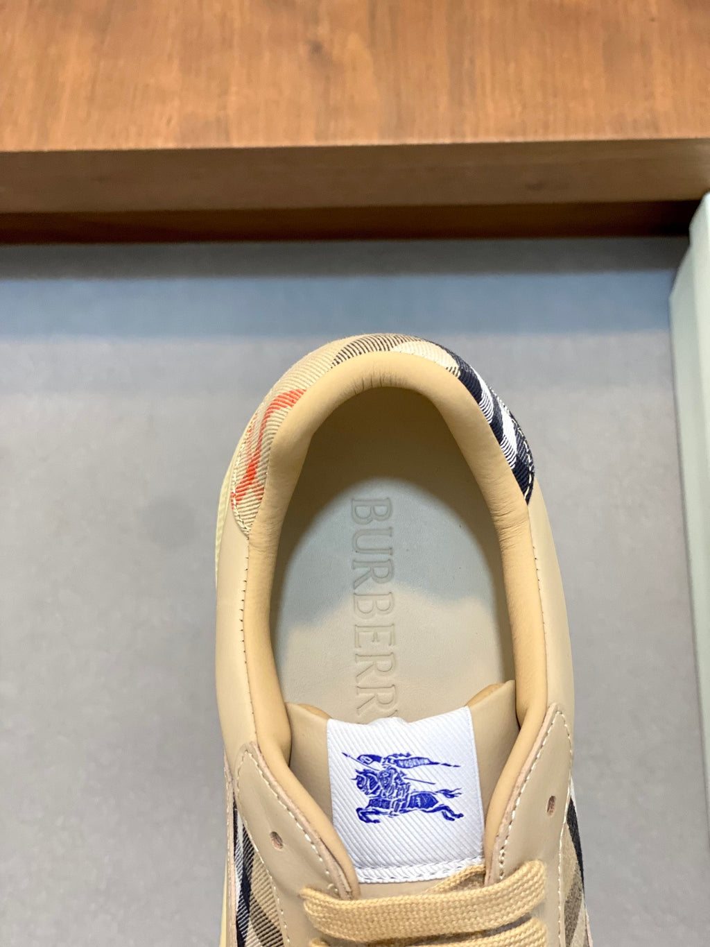 Burberry beige sneakers, heel view with blue check lining and logo label