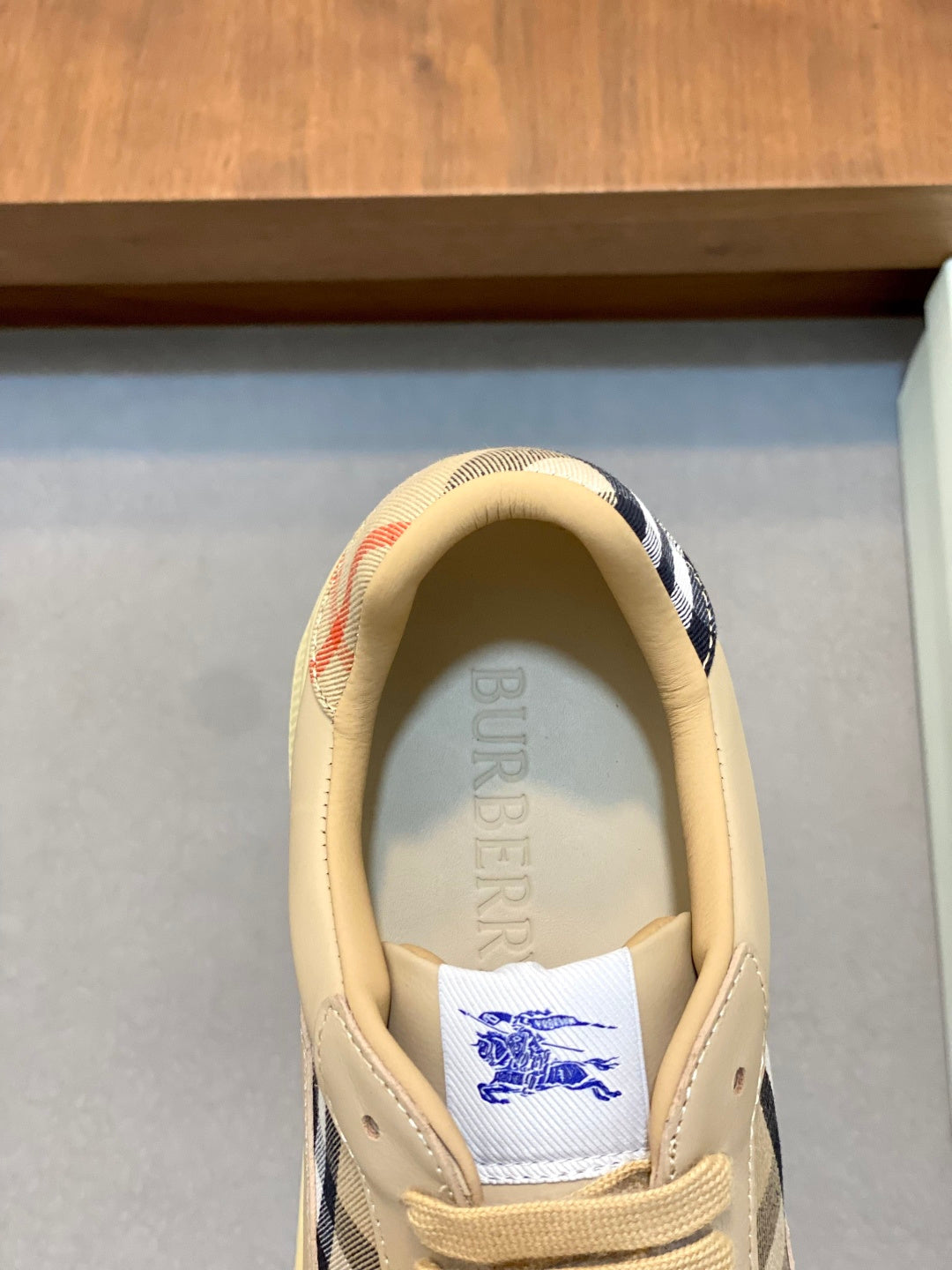 Burberry beige sneakers, heel view with blue check lining and logo label