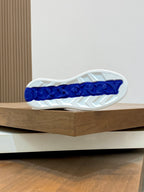 Sneaker outsole with textured tread and blue Burberry lettering at the heel