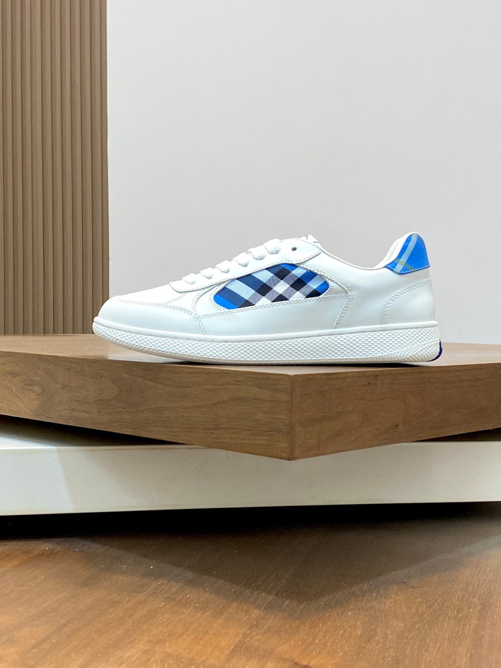White low-top sneaker with blue check front panel and blue heel detail