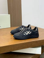 Burberry low-top sneakers pair, dark style with check strap and textured blue sole