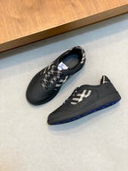 Burberry low-top sneakers, dark pair with check panel and blue trim at sole
