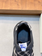 Burberry sneaker interior view, dark collar with blue logo on the lining