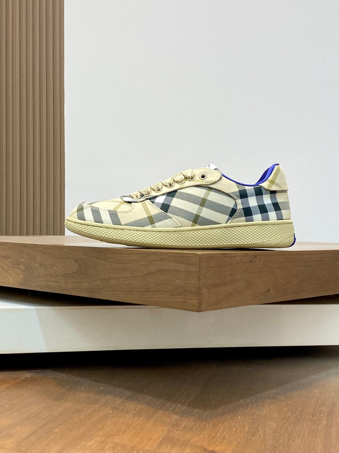Burberry check low-top sneakers, beige plaid upper with blue trim and lace-up.