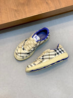 Pair of Burberry check sneakers, beige plaid uppers with blue lining and textured sole.