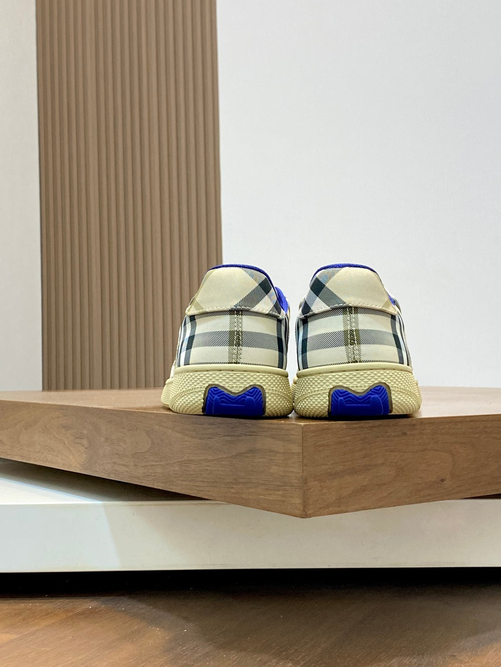 Burberry check sneakers, rear heel with plaid panels and blue rubber heel tab.