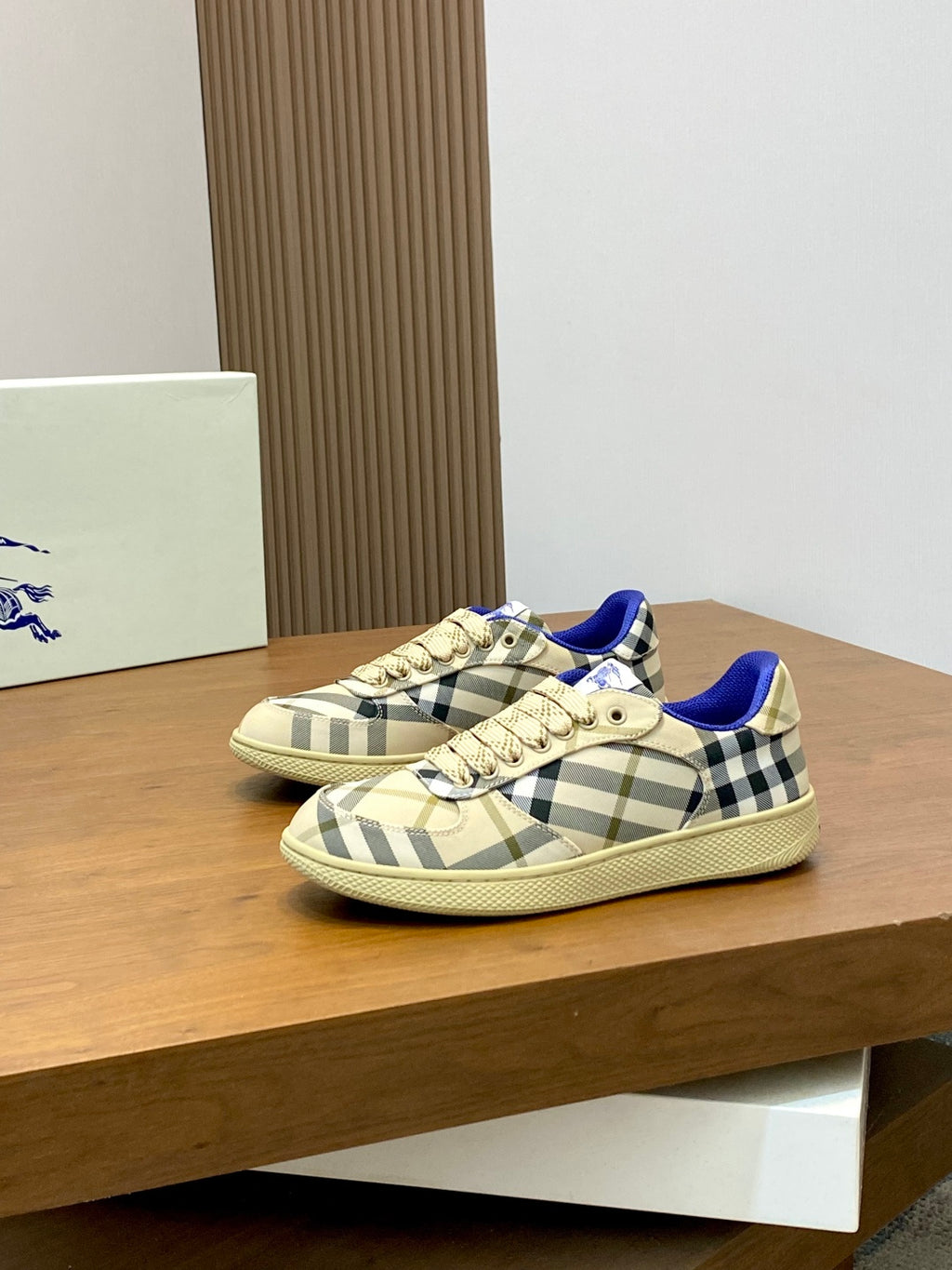 Burberry check low-top sneakers, beige plaid pattern with blue lining and cream laces.
