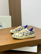 Burberry check low-top sneakers, beige plaid pattern with blue lining and cream laces.