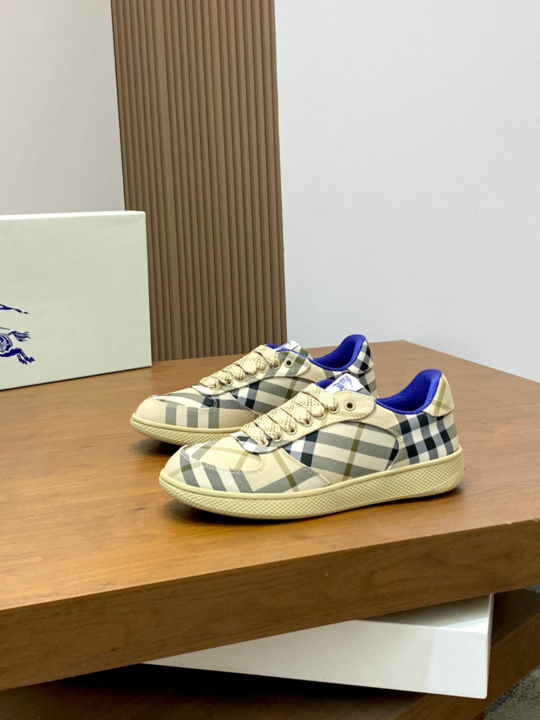 Burberry check low-top sneakers, beige plaid pattern with blue lining and cream laces.