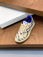 Burberry check low-top sneaker, beige plaid upper with blue collar and cream laces.