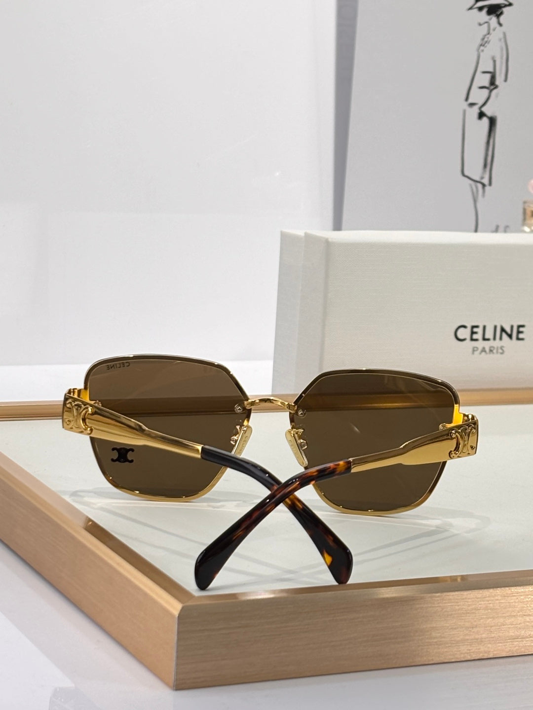 Celine sunglasses with gold-tone frame and dark brown tinted lenses, small rounded shape