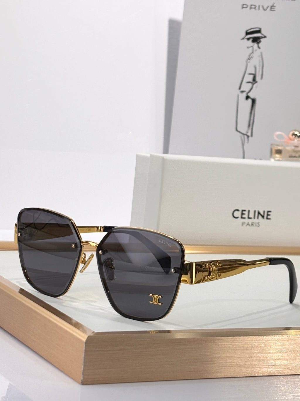 Celine sunglasses with gold-tone frame and black tinted lenses, rounded square silhouette