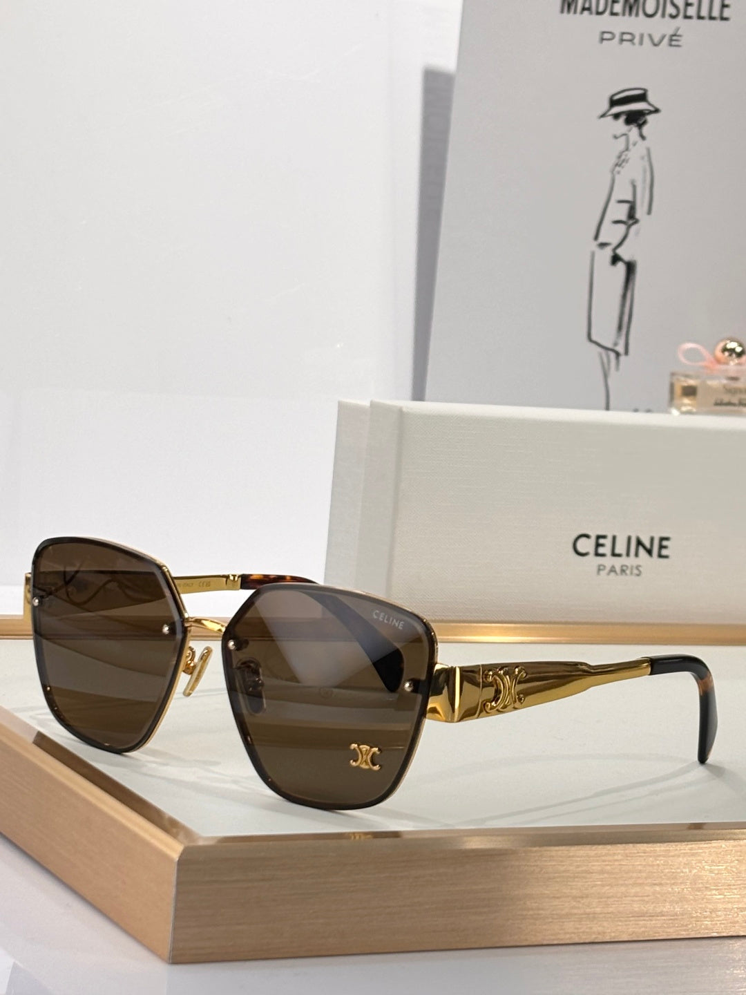 Celine sunglasses with gold-tone frame and dark brown tinted lenses, rounded square shape