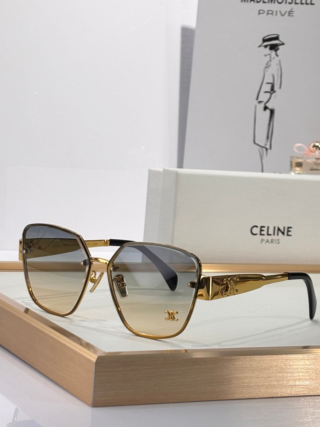 Celine sunglasses with gold-tone frame and smoke gray tinted lenses, rounded-square shape