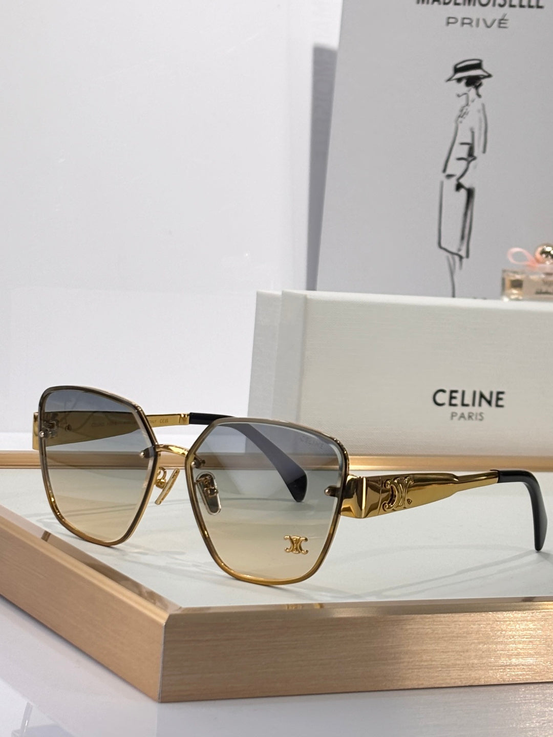 Celine sunglasses with gold-tone frame and smoke gray tinted lenses, rounded-square shape