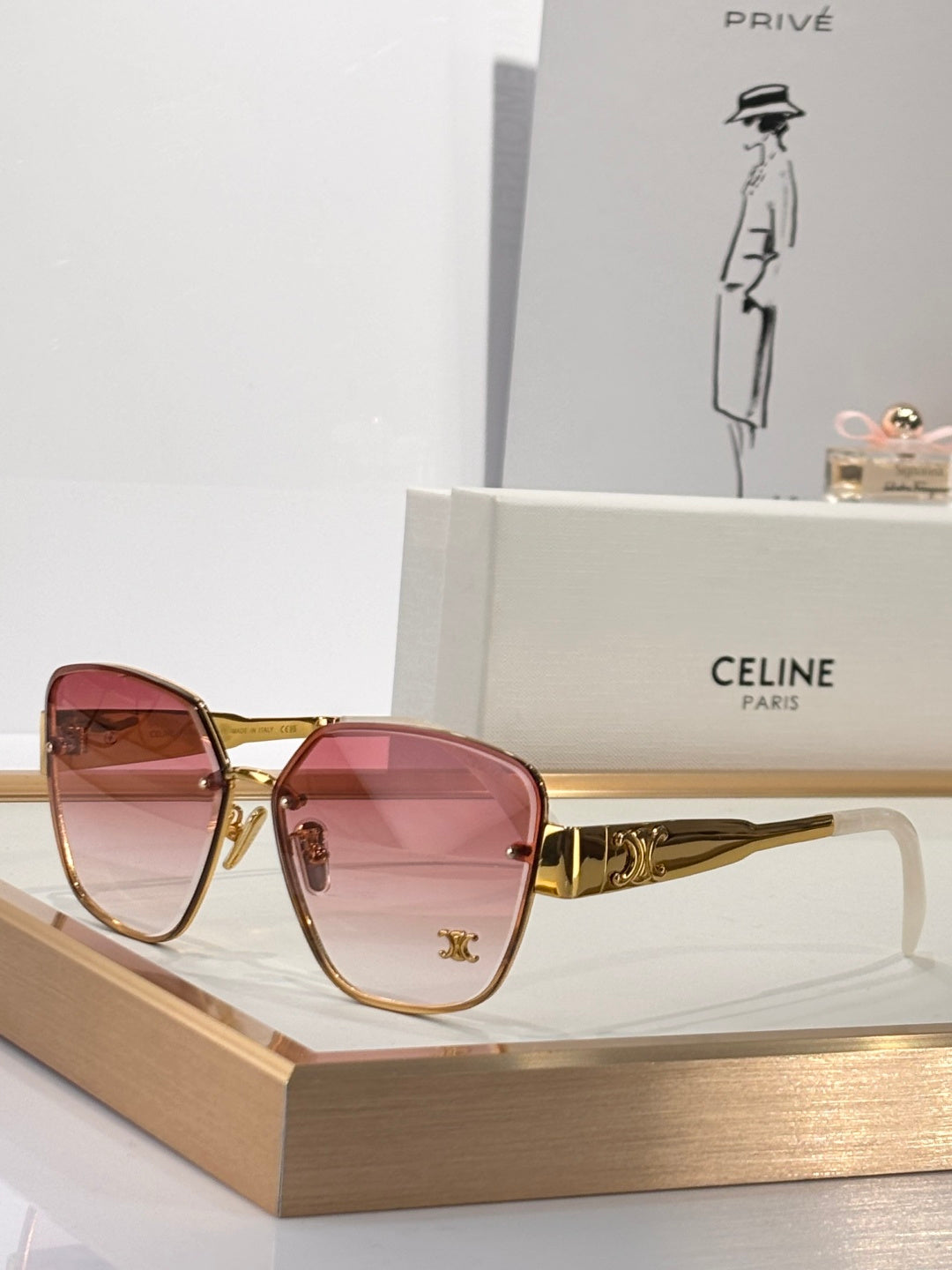 Celine sunglasses with gold-tone frame and pink tinted lenses, rounded square shape
