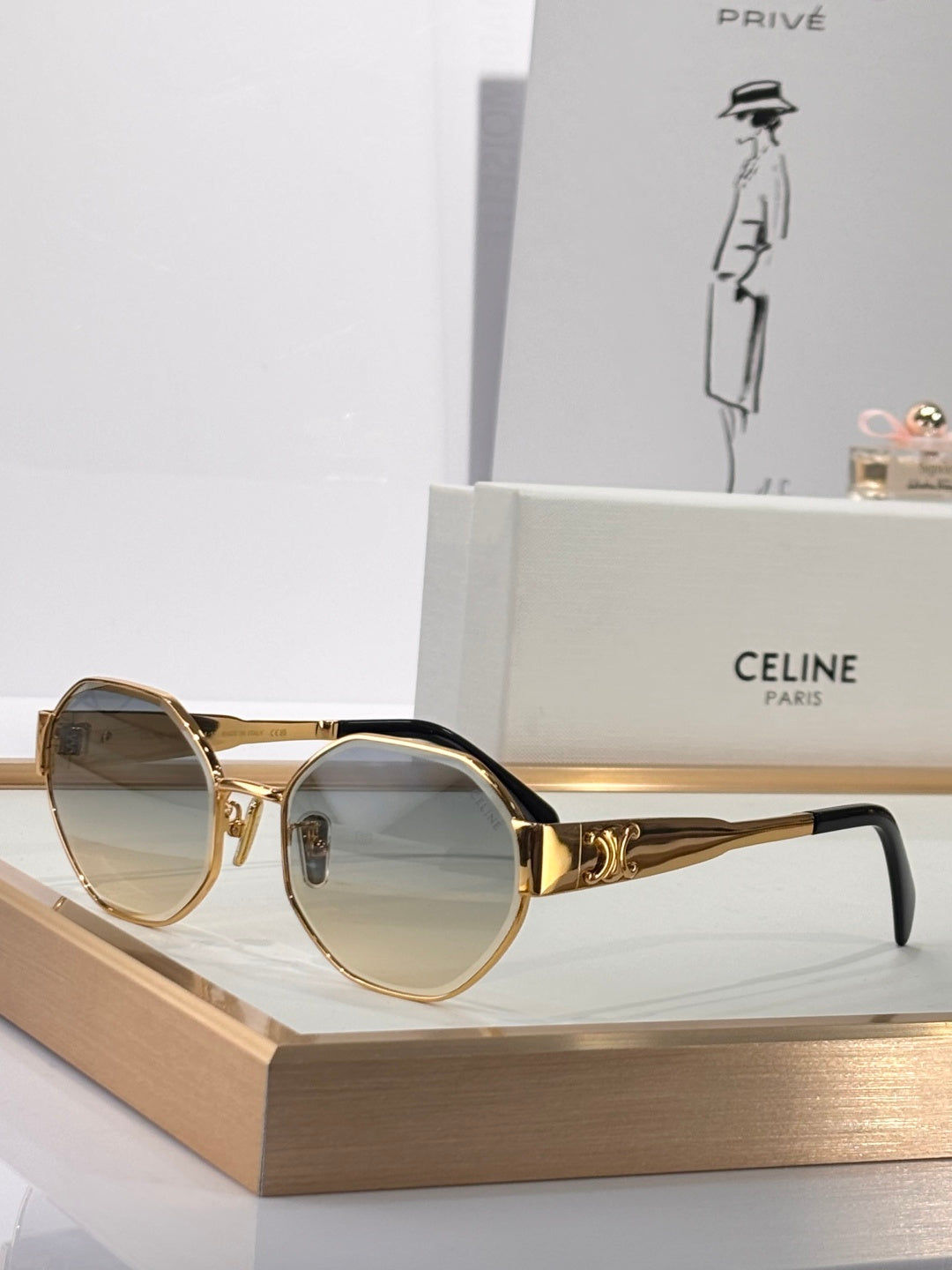 Celine sunglasses with gold round frames and amber tinted lenses