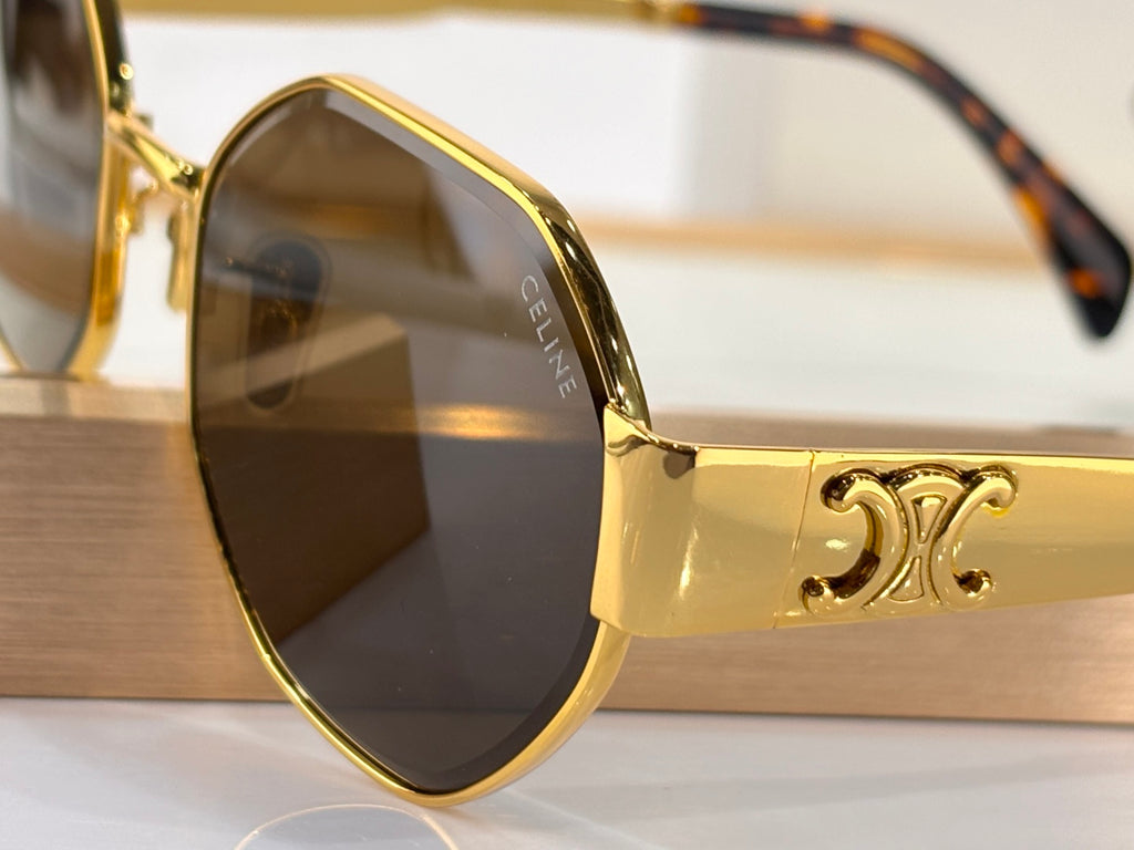 Celine sunglasses close-up: round gold frame with dark tinted lens and arm