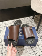 Dior brown leather slide sandals with front and side buckled straps, close-up