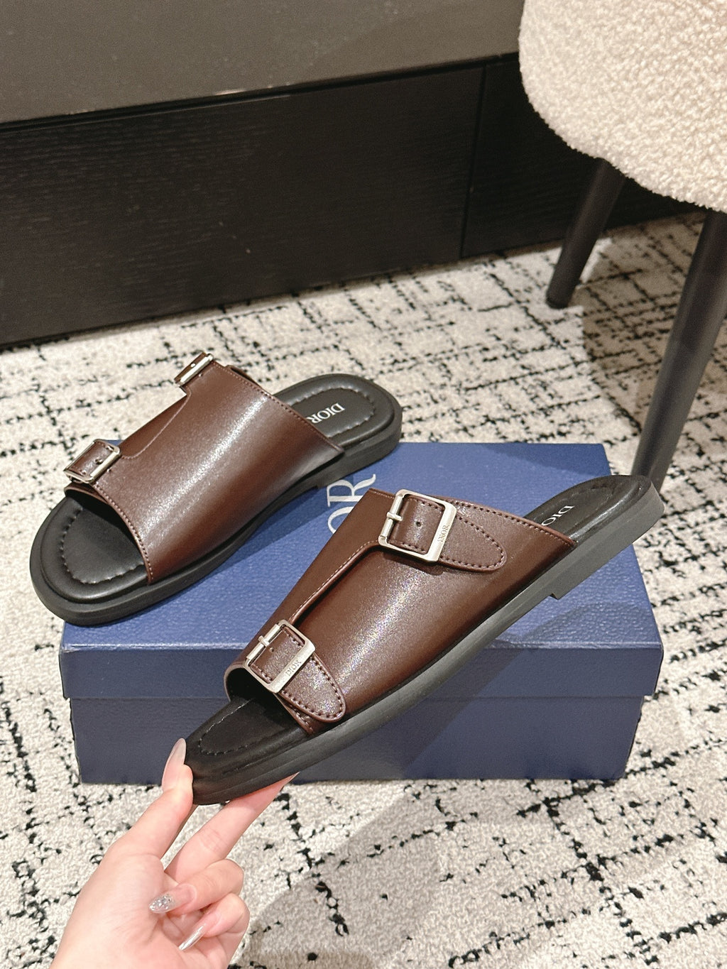 Dior brown leather slide sandals angled view with two adjustable buckle straps